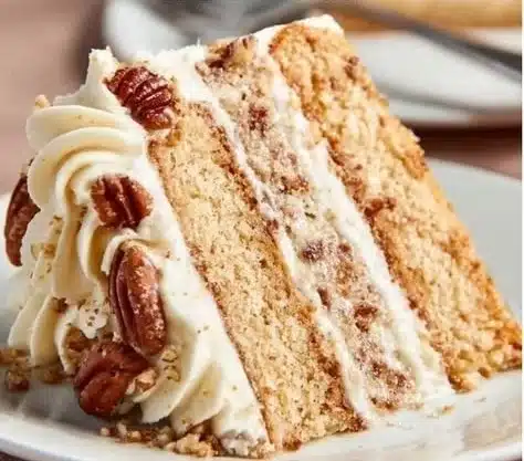 Delicious Butter Pecan Cake with nuts and caramel topping on a rustic wooden table