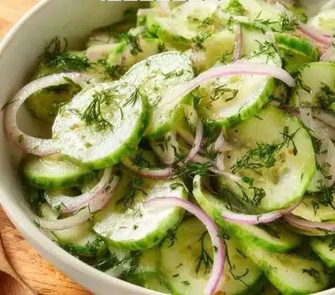 Cucumber Salad 3 Fresh cucumber salad with herbs and dressing served in a bowl