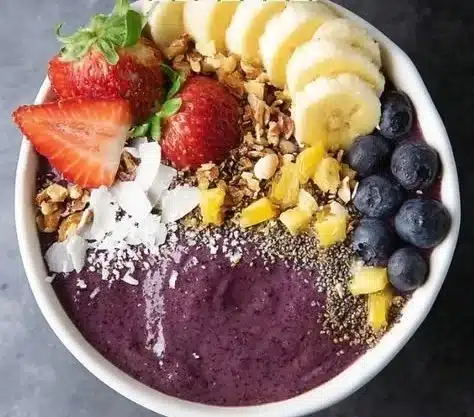 A deliciously vibrant acai bowl topped with fresh fruits and granola