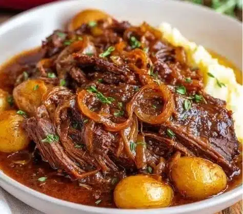 Delicious French Onion Pot Roast served with melted cheese and herbs.