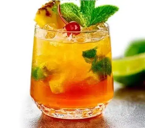 Delicious homestyle Mai Tai cocktail garnished with mint and lime.